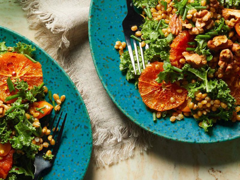 Hearty Kale Salad with Warm Citrus and Wheat Berries on blue plates