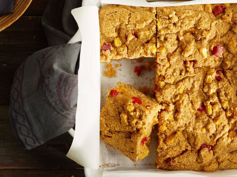 Vegan Cornbread in a white square dish with parchment paper underneath
