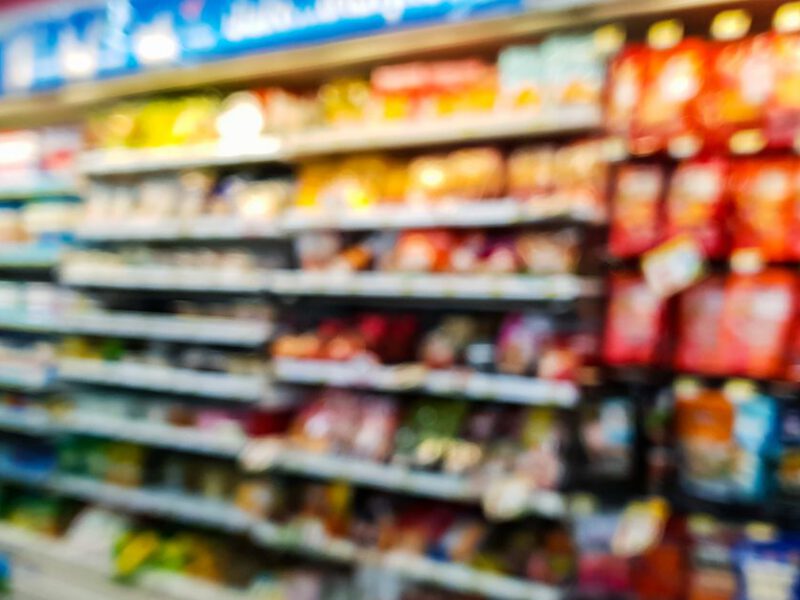 blurry photo of food in the refrigerated section of a grocery store