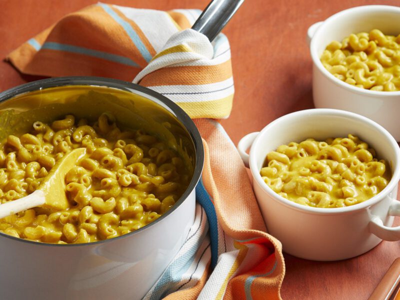 Stove-Top Mac and Cheese in a metal bowl on an orange tablecloth