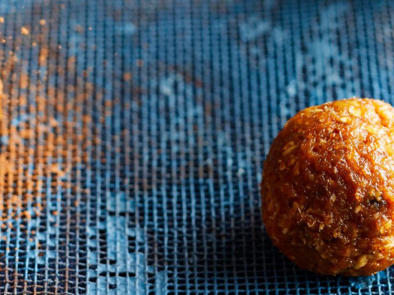 Mexican Chocolate Energy Bites on a blue wood tabletop