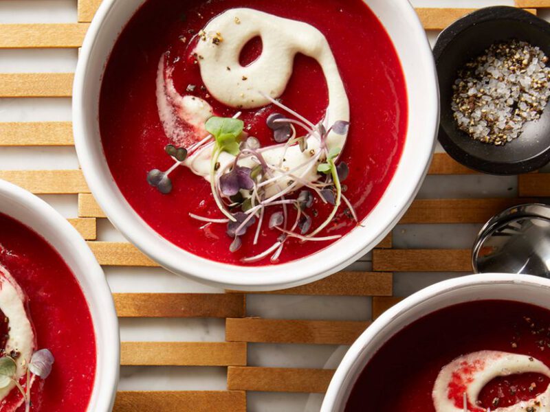 Springtime Beet Soup in white bowls on a wooden lattice placemat