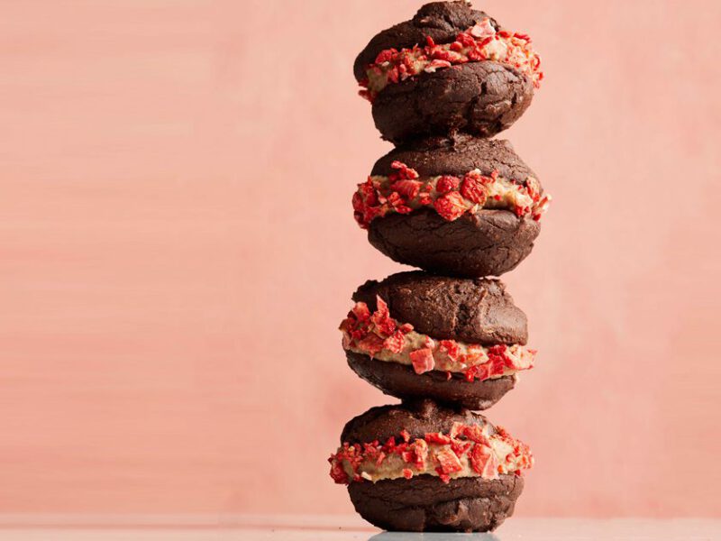 Chocolate-Strawberry Vegan Whoopie Pies in a stack against a pink background