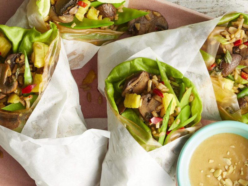Stir-Fry Wraps with Peanut Dipping Sauce on a pink tray