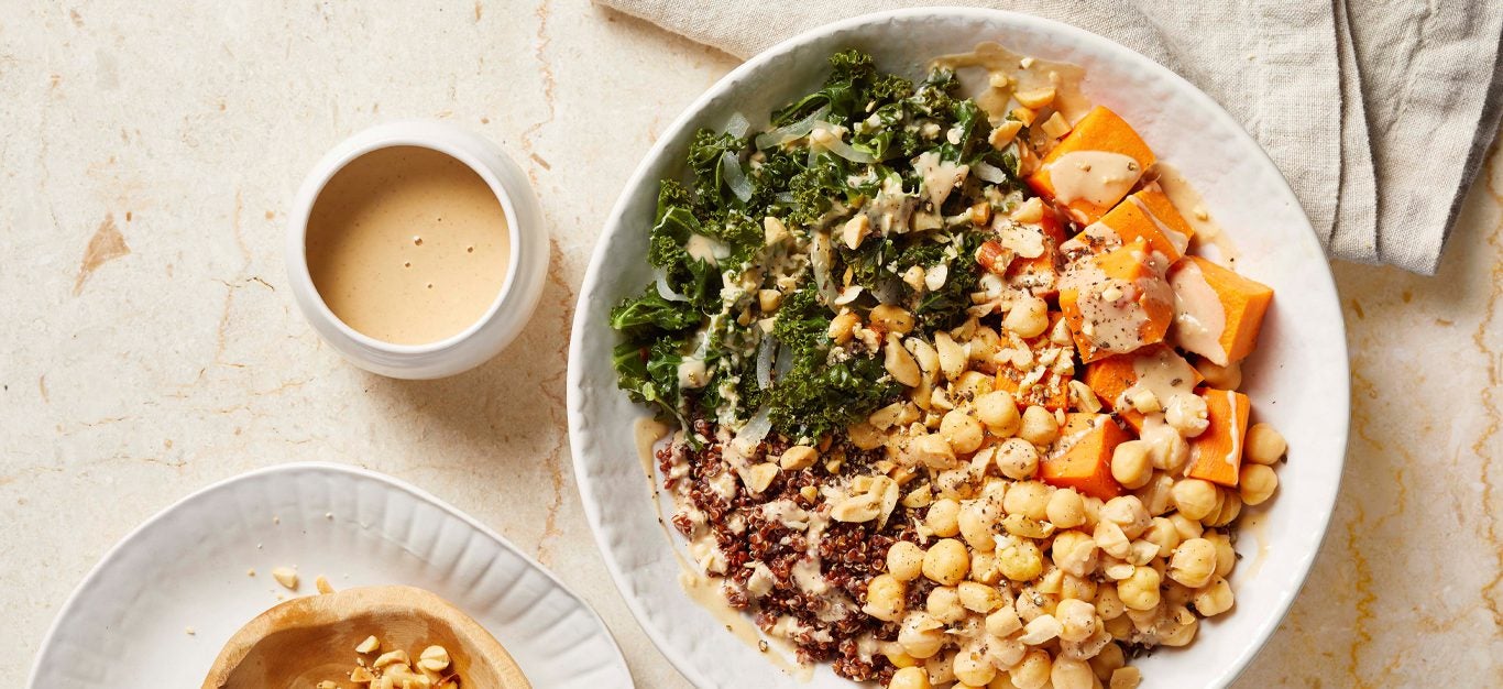 Quinoa-Chickpea-Sweet Potato Bowls with Peanut Sauce in white bowls