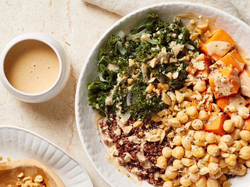 Quinoa-Chickpea-Sweet Potato Bowls with Peanut Sauce in white bowls