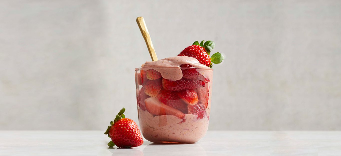 The Best Vegan Strawberries and Cream in a glass cup with gold spoon