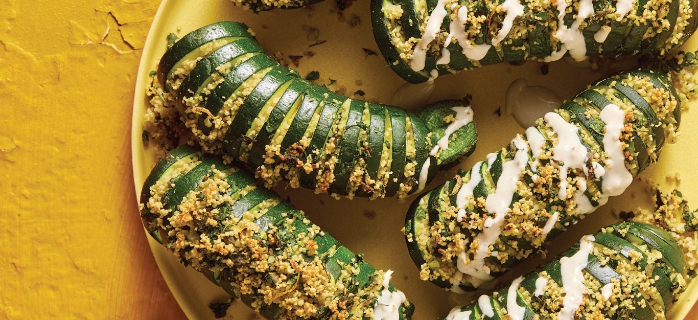 Hasselback Roasted Zucchini on a yellow plate and background