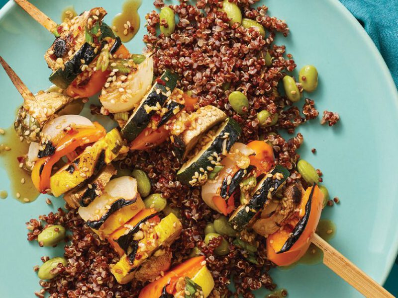 Summer Squash Veggie Skewers Over Edamame Quinoa on a blue plate