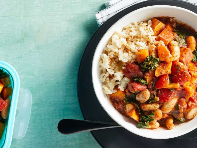 Microwave Sweet Potato and Kale Chili in a white bowl on a black plate
