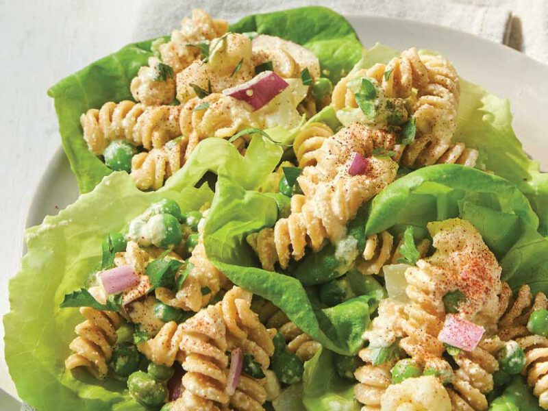 Cauliflower Pasta Salad Wraps in a white dish with a glass of water and metal fork