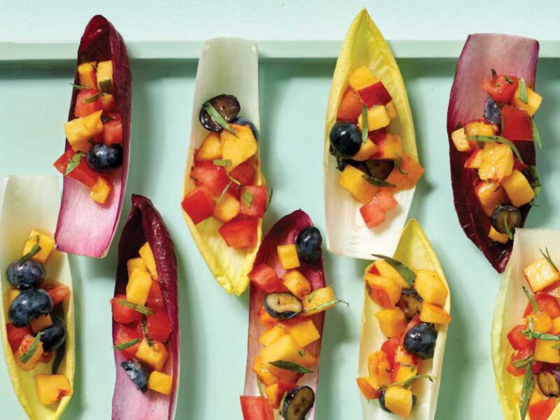 Endive Boats with Summer Fruit on a light blue platter