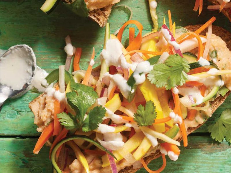 Open-Face Vegan Banh Mi Sandwiches on a green wooden table