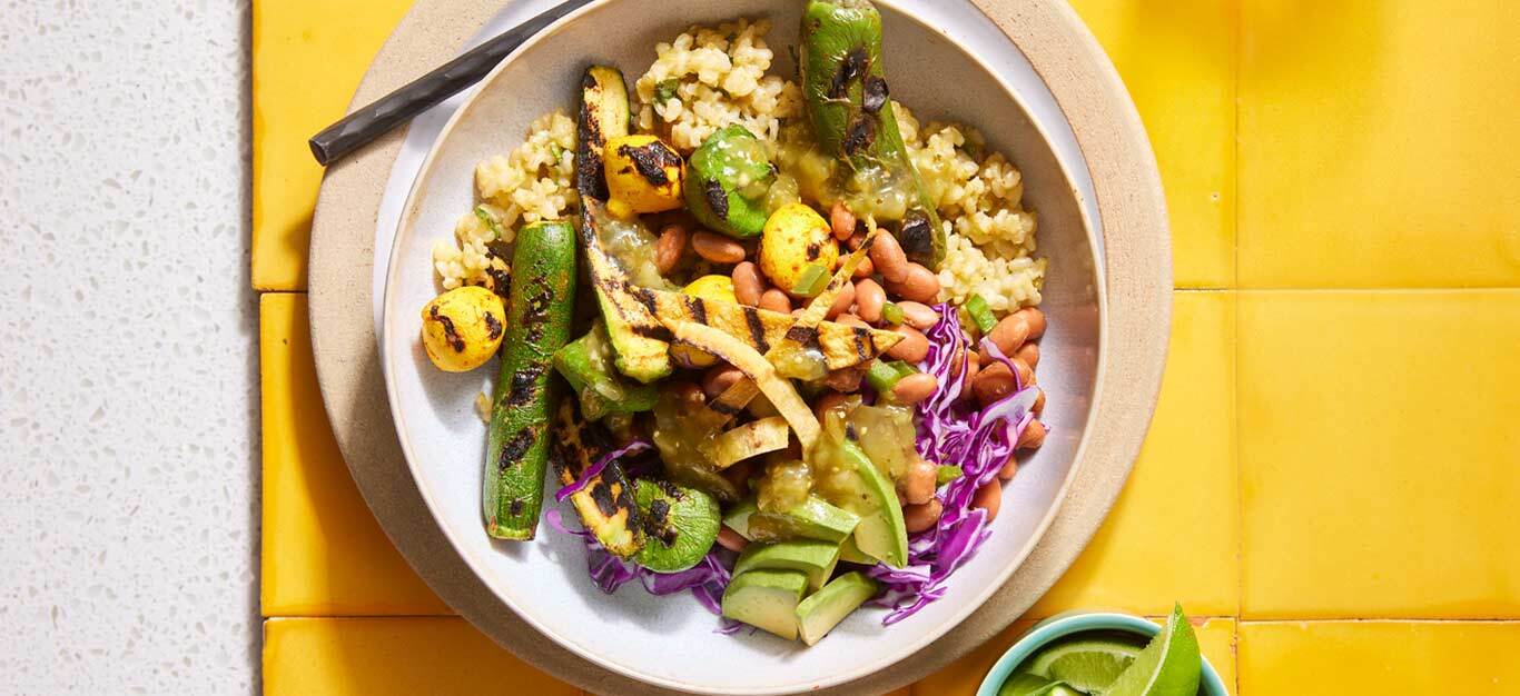 Baja Rice Bowls with Grilled Summer Squash on a yellow tile table