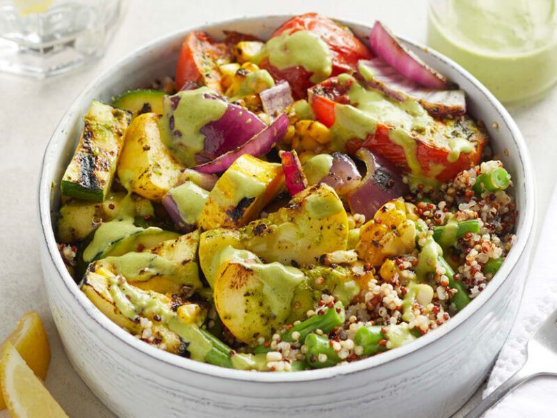 Pesto Grain Bowl with Grilled Vegetables in a white bowl with a metal fork