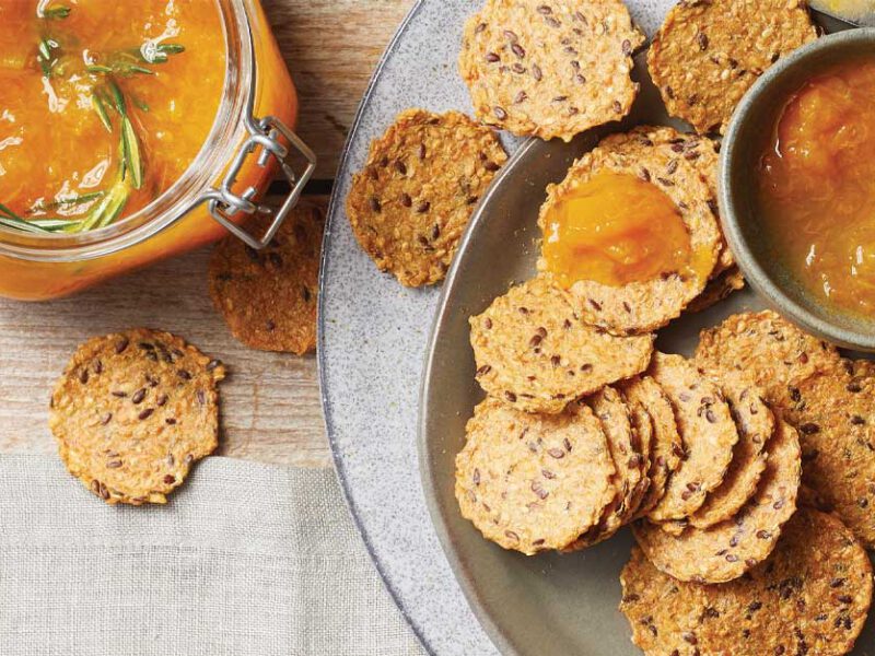 Rosemary-Apricot Preserves with seeded crackers on a gray plate