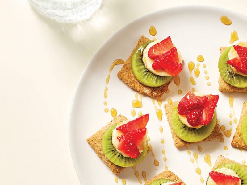 Walnut Biscuit Stacked Fruit Appetizers on a white plate against a cream background