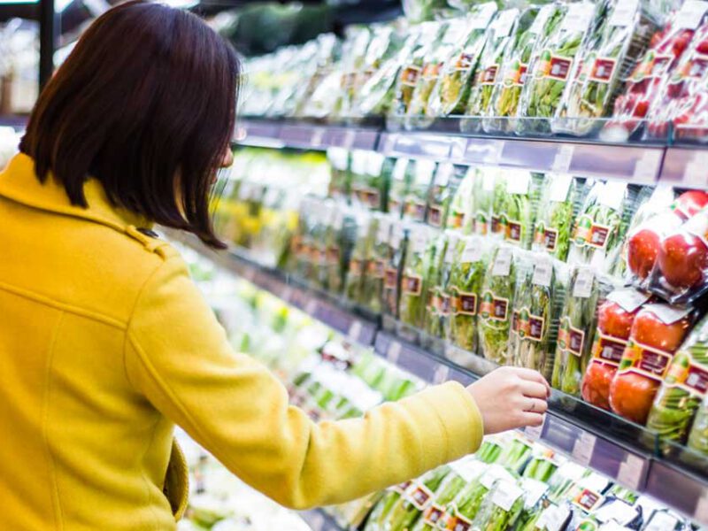 Young woman shopping in the supermarket produce section