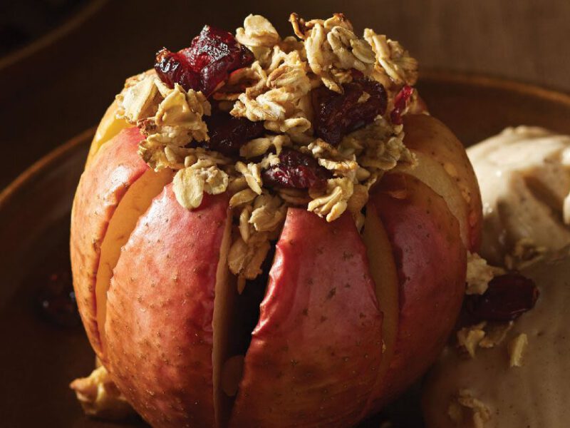 Blooming Apples with Cinnamon Nice Cream on a black plate and wood tabletop