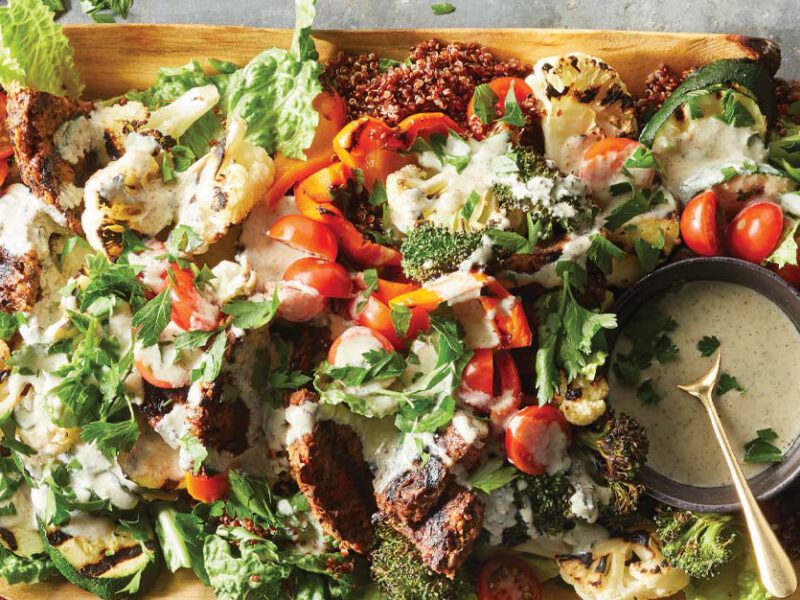 Vegan Mixed Grill Platter on a wooden tray with a small bowl of ranch dressing on the righthand side of the platter