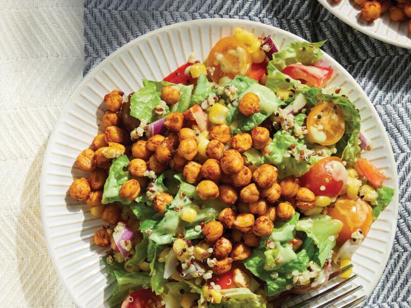 Chopped Salad with Air-Fried BBQ Chickpeas on a white plate against a herringbone pattern tablecloth