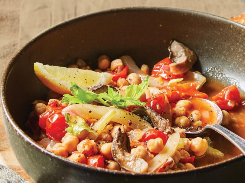 King Oyster Vegan Cioppino in a gray bowl with a metal spoon