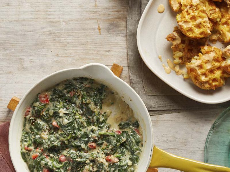 Waffled Smashed Potatoes with Creamed Spinach on white plates
