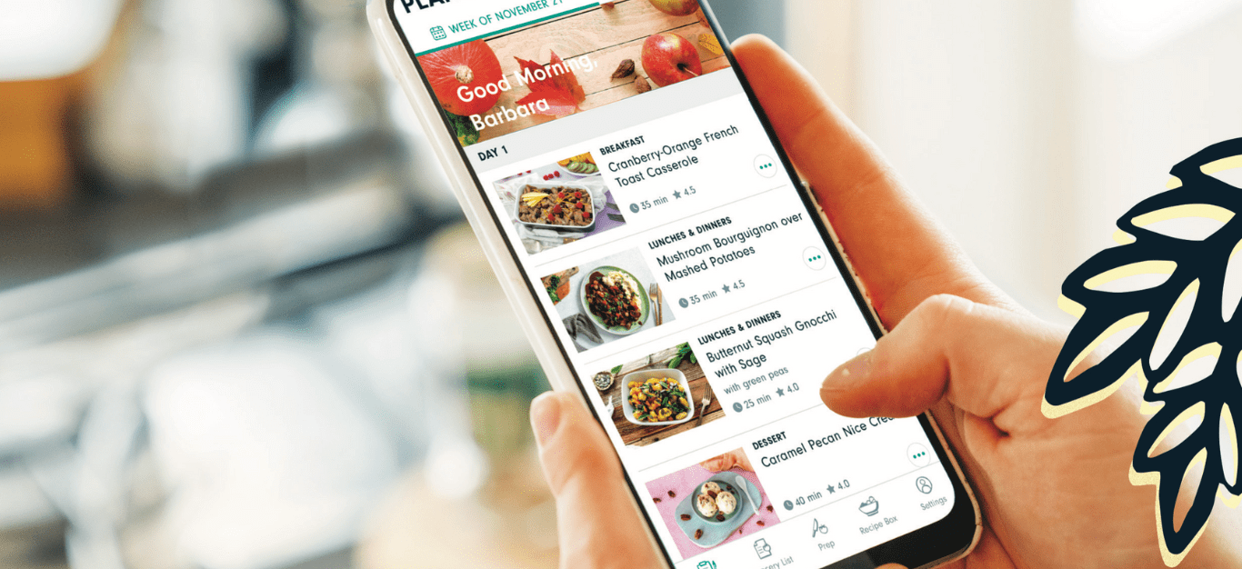 Hand holding an iPhone with Forks Meal Planner on the screen