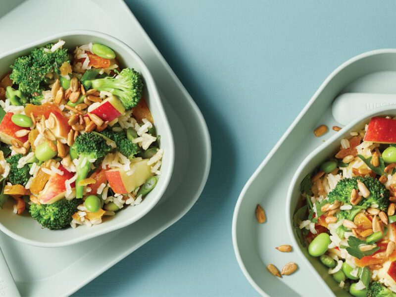 Kid-Friendly Chopped Salad in white plastic bowls with plastic utensils on a blue background