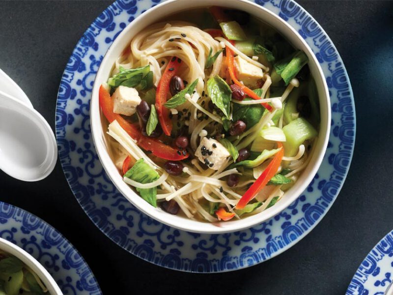 Rice Vermicelli Bowls with Bok Choy and Adzuki Beans in blue and white porcelain bowls with soup spoons