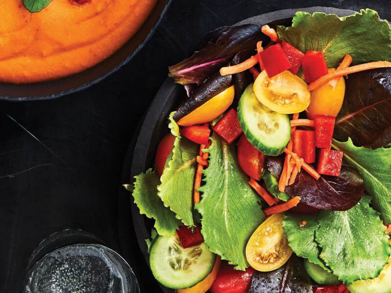 Rainbow Veggie Salad with Creamy Harissa Dressing in a black bowl