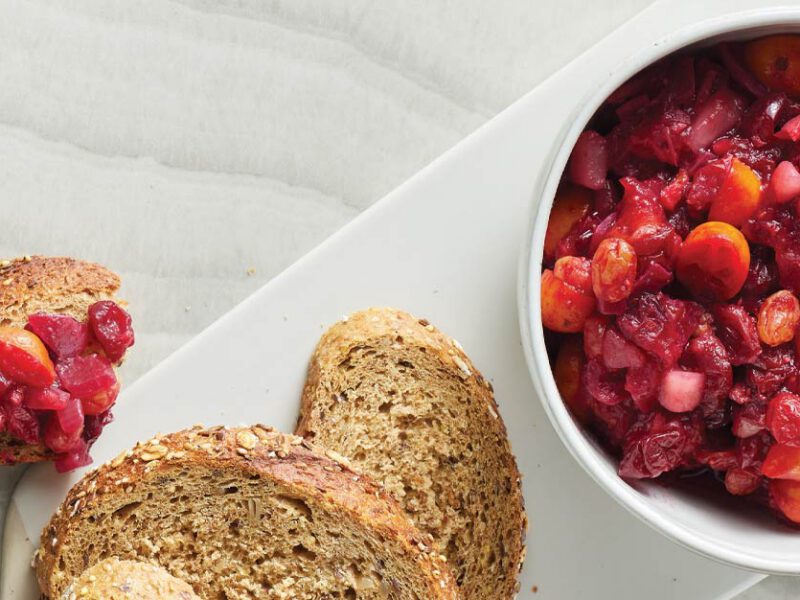 Cranberry-Kumquat Chutney in a small white bowl with sliced bread