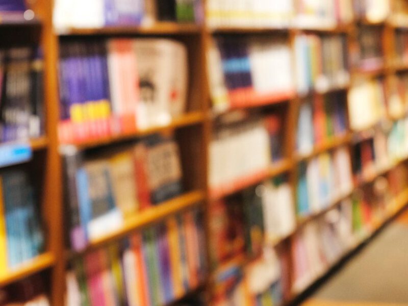 A blurred image of books on the shelves of a bookstore