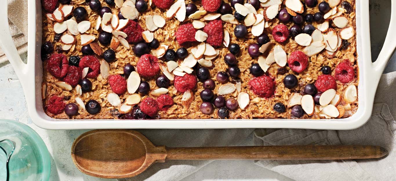 Oatmeal Breakfast Bake with Berries and Almonds in a white casserole dish