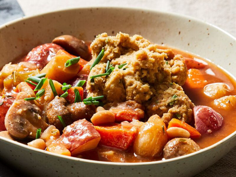 Vegetable Stew with Herbed Dumplings in a white ceramic bowl