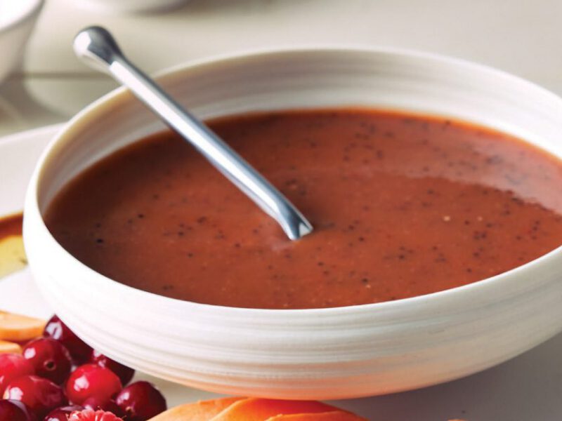 Sweet Potato Poppy Seed Dressing in a white bowl with a metal spoon