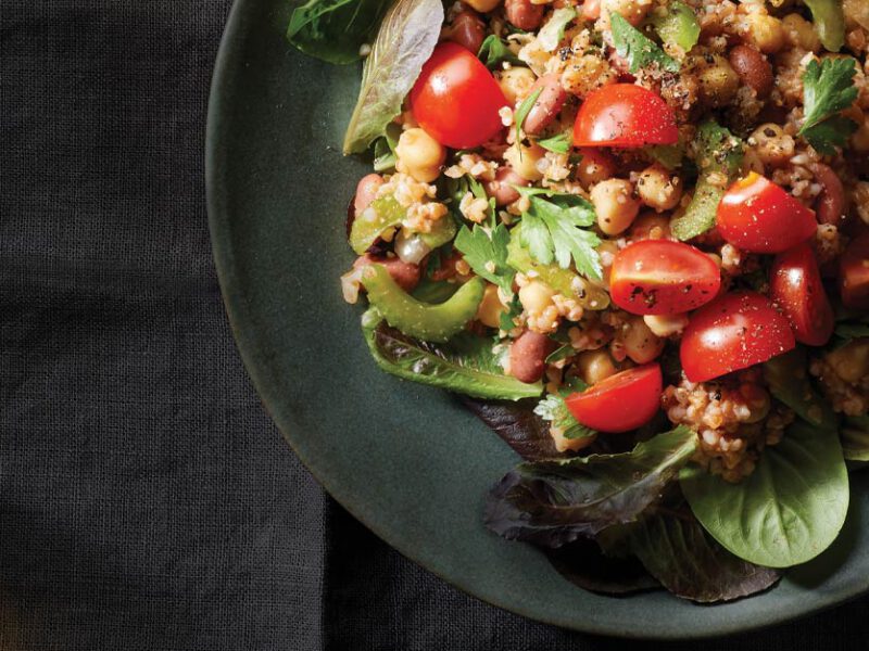 Bulgur-Bean Salad with Tomato Vinaigrette on a gray ceramic plate with a green cloth napkin
