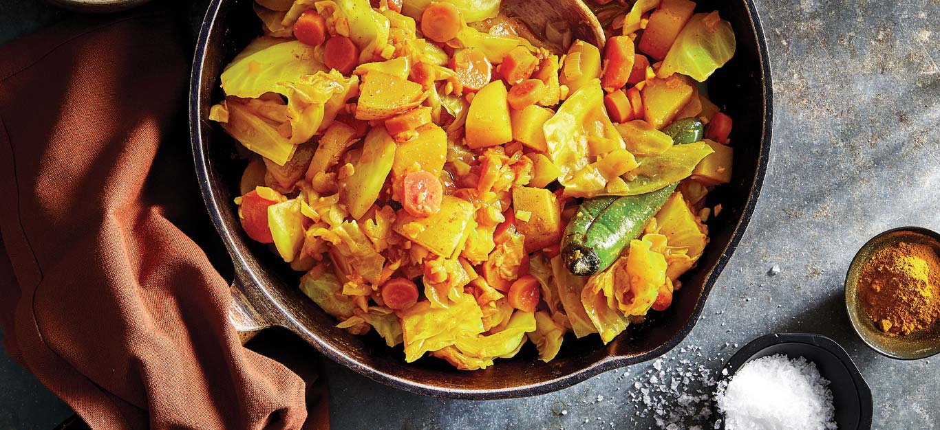 Tikil Gomen (Ethiopian-Style Cabbage, Potatoes, and Carrots) in a cast iron skillet