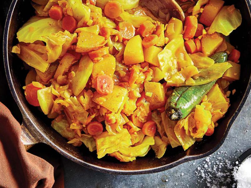 Tikil Gomen (Ethiopian-Style Cabbage, Potatoes, and Carrots) in a cast iron skillet