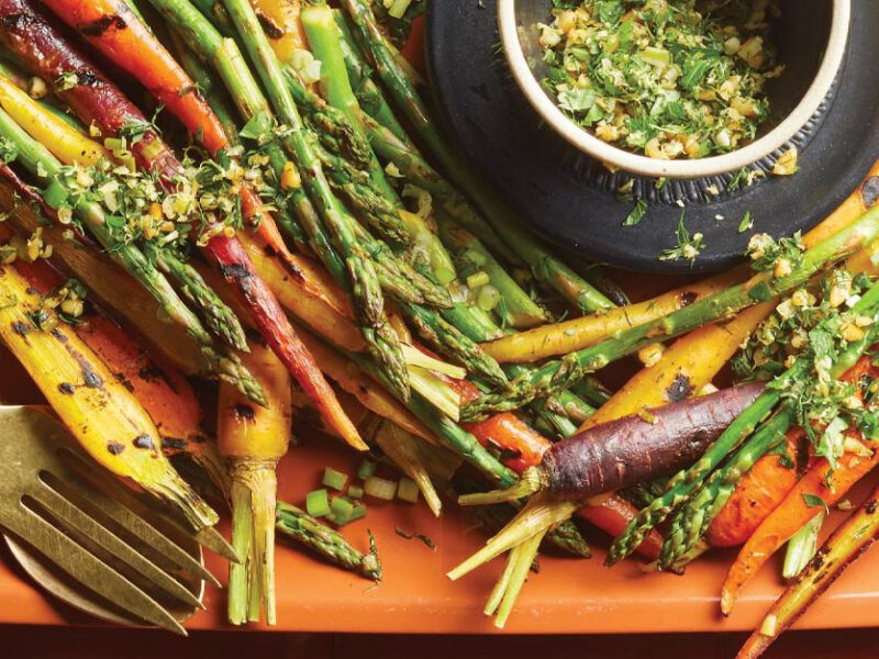 Grilled Asparagus and RainbowCarrots with Gremolata on an orange plastic serving tray