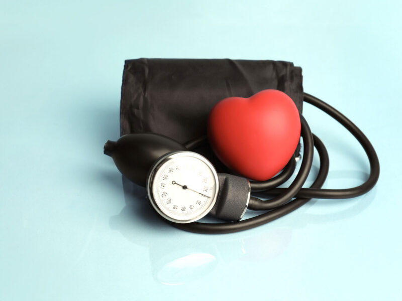 Blood pressure cuff with a palm-sized red heart next to it