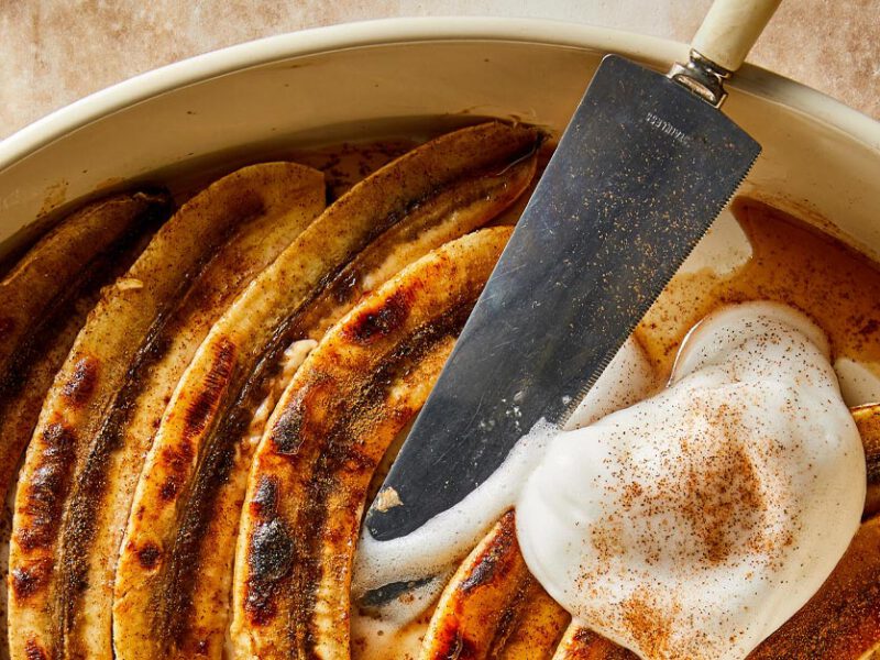 Healthy Vegan Bananas Foster with aquafaba whipped cream in a white casserole dish
