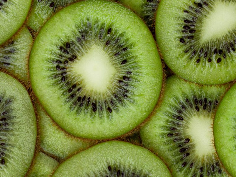 Overlapping slices of kiwi shown close up