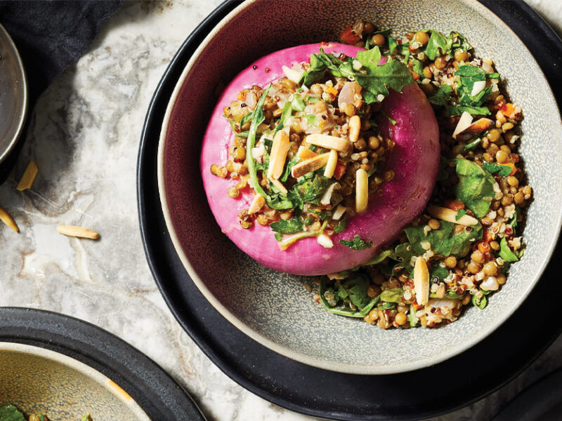 Provençal Stuffed Onions with Lentils, Quinoa, and Kale in white ceramic bowls
