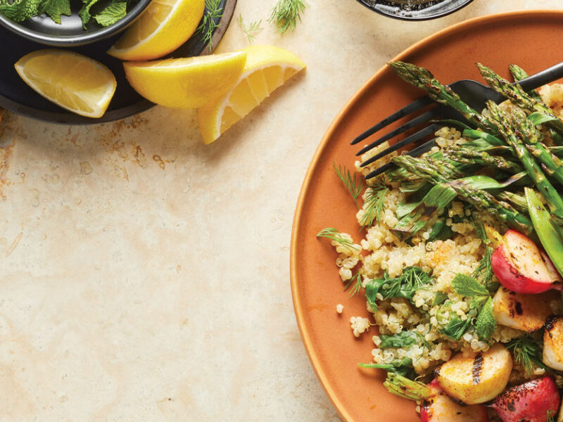 Quinoa Pilaf Primavera on orange plates with a metal fork