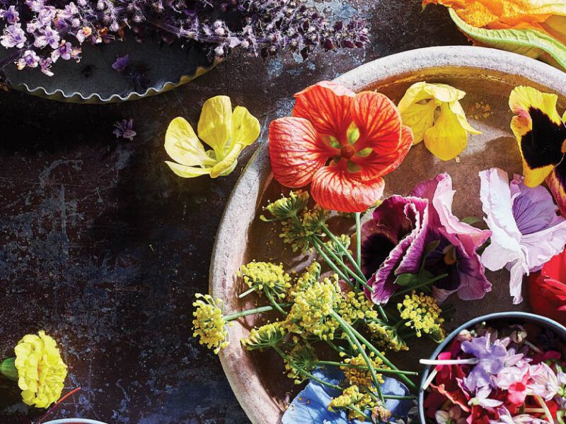 White ceramic bowl full of edible flowers