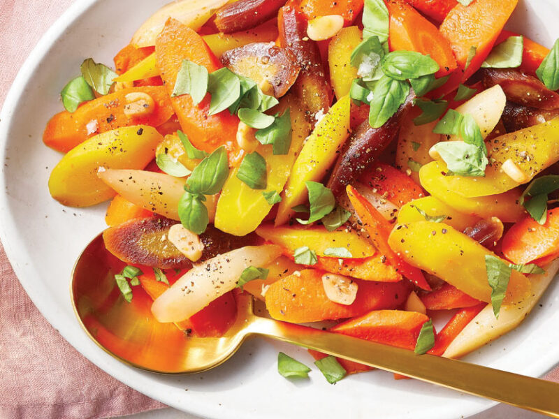 Basil and Garlic Poached Carrots on a white serving platter