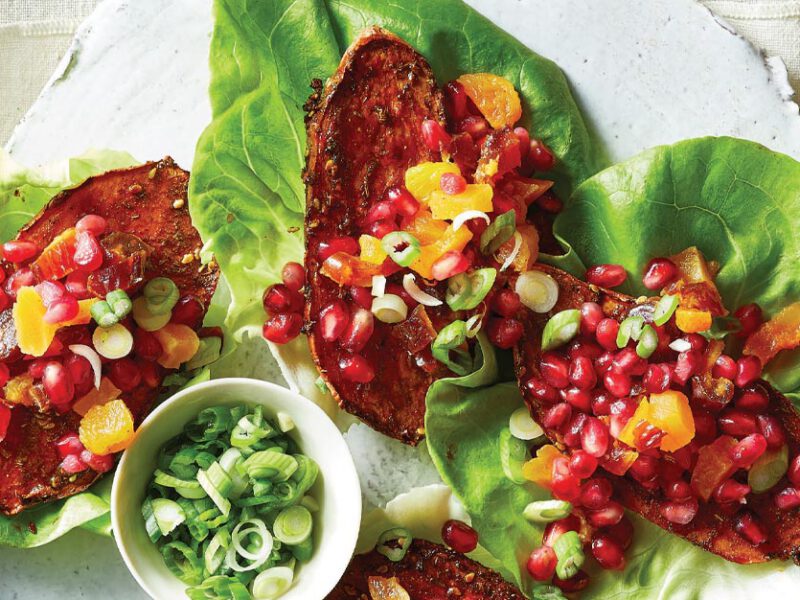 Za'atar Sweet Potato Lettuce Cups next to a small bowl of sliced scallions on a white background