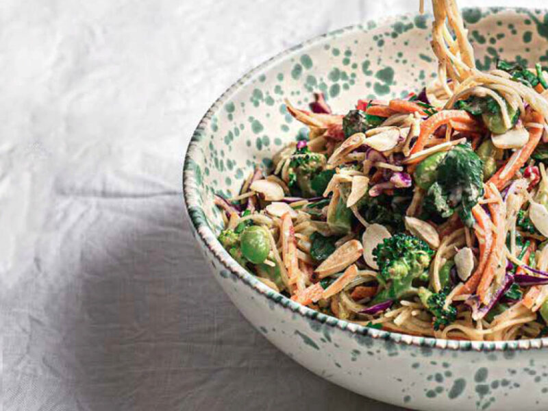 Saucy Vermicelli with Vegetables and Fresh Herbs in a speckled white ceramic bowl