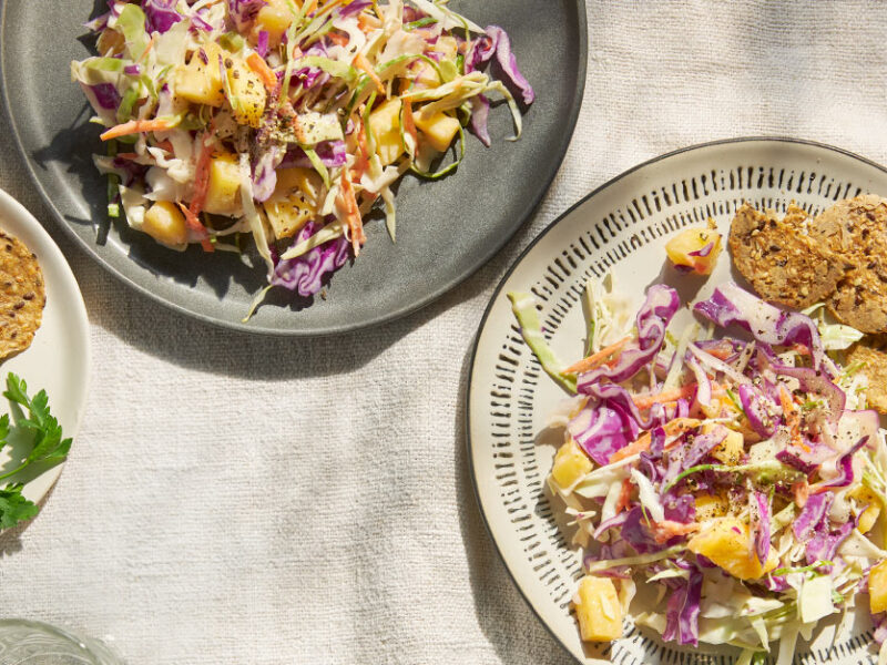 Vegan Pineapple Coleslaw on two ceramic plates with whole grain crackers